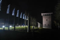 Flood lights illuminate a guard tower at the Birkenau Nazi death camp in Oswiecim, Poland, Saturday, Jan. 27, 2024. Survivors of Nazi death camps marked the 79th anniversary of the liberation of the Auschwitz-Birkenau camp during World War II in a modest ceremony in southern Poland.(AP Photo/Czarek Sokolowski)