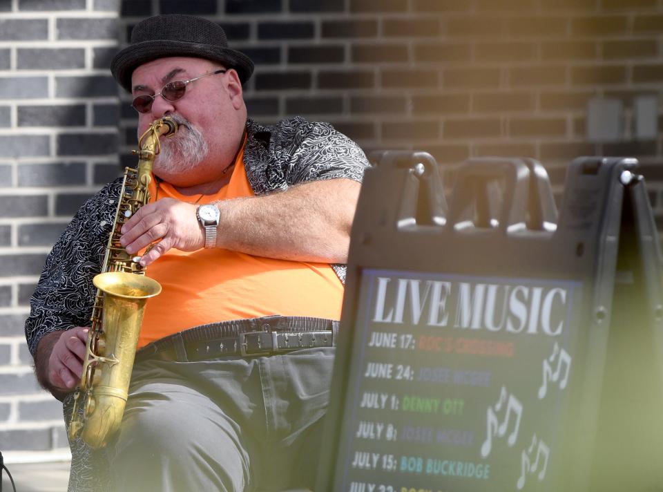 Musician Denny Ott performs at the Canton Farmers Market in downtown Canton.