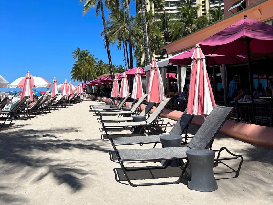 Beach chairs and umbrellas at the Royal Hawaiian hotel.