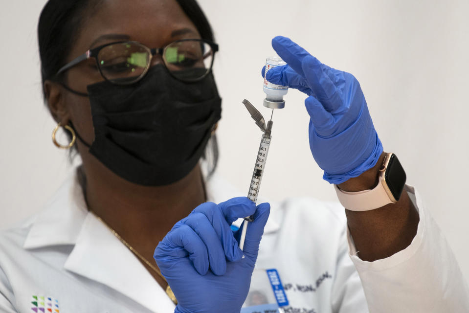 FILE - In this Dec. 21, 2020, file photo, Michelle Chester, director of employee health services at Northwell Health, prepares the Moderna COVID-19 vaccine at Northwell Health's Long Island Jewish Valley Stream hospital in Valley Stream, N.Y. Hospitals and nursing homes across the country are preparing for worsening staff shortages as state deadlines arrive for employees to get vaccinated against COVID-19. New York health care employees had until the end of the day Monday, Sept. 27, 2021, to get at least one dose. (Eduardo Munoz/Pool Photo via AP, File)