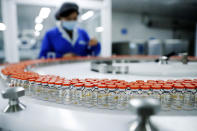 FILE - In this Dec. 23, 2020, file photo released by China's Xinhua News Agency, a Sinovac worker checks the labeling on vials of COVID-19 vaccines on a packaging line in Beijing. With just four of China’s many vaccine makers claiming they are able to produce at least 2.6 billion doses this year, a large part of the world’s population will end up inoculated not with Western vaccines boasting headline-grabbing efficacy rates, but with China’s traditionally made shots. (Zhang Yuwei/Xinhua via AP, File)