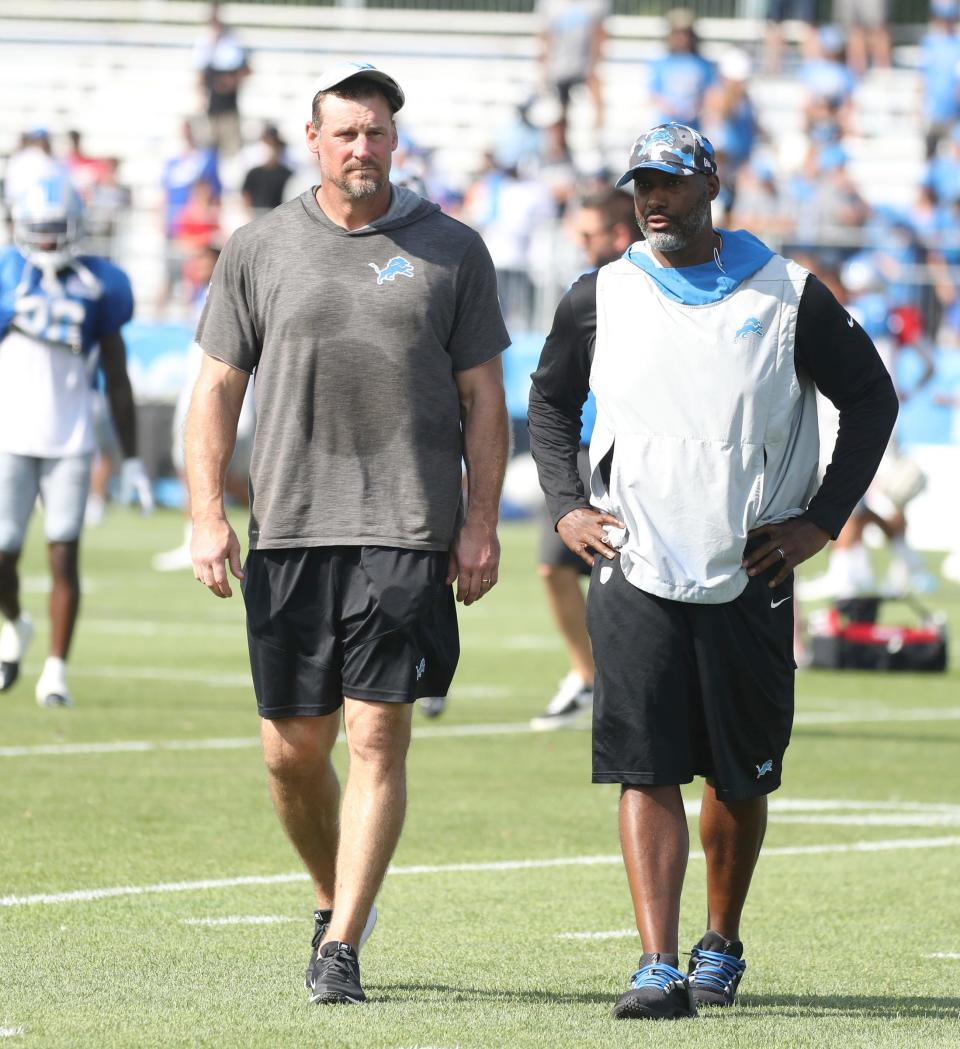 Lions head coach Dan Campbell and general manager Brad Holmes walk off the field during preseason camp's first practice with pads Aug. 1, 2022 in Allen Park.