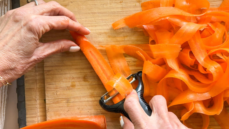 hand peeling carrot