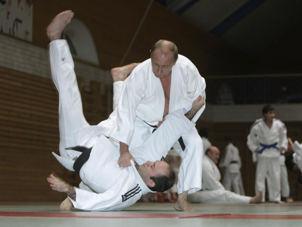 Putin (top) attends a judo training session at the Top Athletic School in St. Petersburg on Dec. 18, 2009.