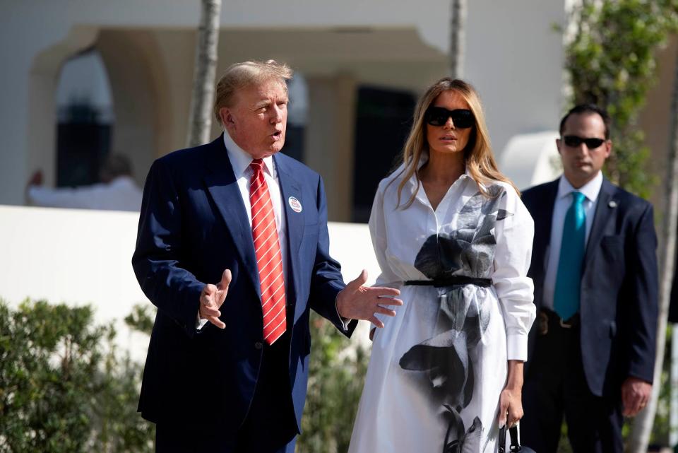 Donald and Melania Trump stand in front of members of the media after casting their votes at the Morton and Barbara Mandel Recreation Center on elections day March 19, 2024 Palm Beach.
