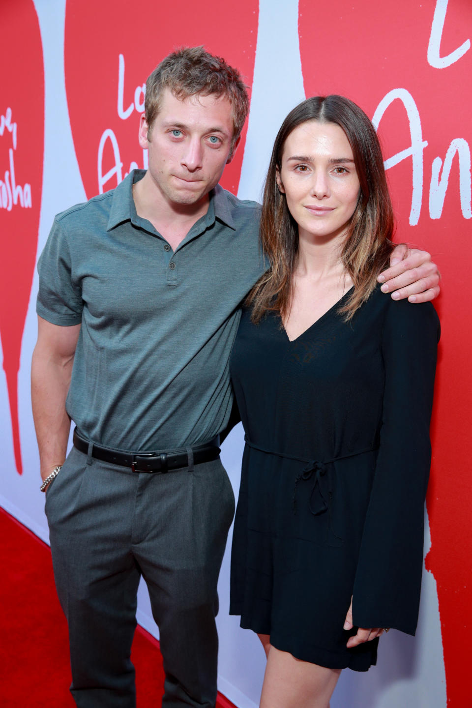 Closeup of Jeremy Allen White and Addison Timlin pose for photographers at a red carpet event