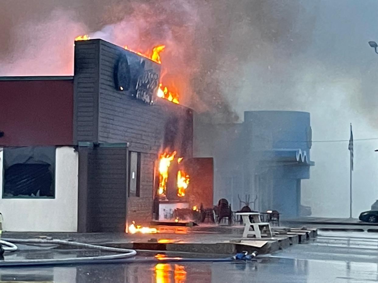 Firefighters battle a blaze at the Clarksville Roosters restaurant on Monday.