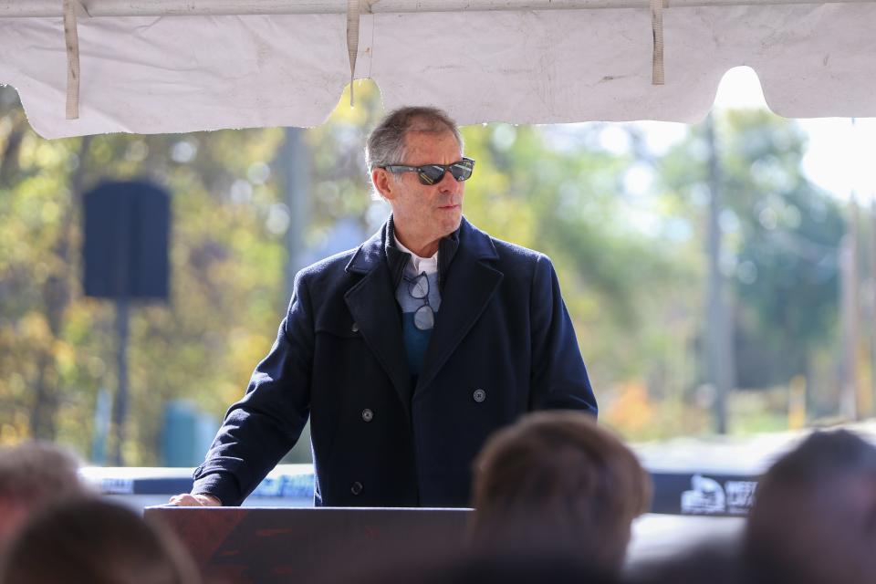 John Dennis speaks to residents and individuals involved with the construction of the River Road project at ribbon cutting ceremony for the reopening of North River Road after an 18th month closure due to construction, on Wednesday, Nov. 1, 2023, in West Lafayette, Ind.