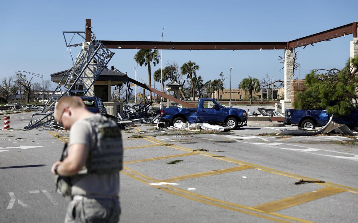<span class="caption">A soldier stands guard at the damaged entrance to Tyndall Air Force Base in Panama City, Florida, Oct. 11, 2018, after Hurricane Michael.</span> <span class="attribution"><a class="link " href="http://www.apimages.com/metadata/Index/Tropical-Weather/925de2623b9f49778674638453ee8de7/24/0" rel="nofollow noopener" target="_blank" data-ylk="slk:AP Photo/David Goldman;elm:context_link;itc:0;sec:content-canvas">AP Photo/David Goldman</a></span>