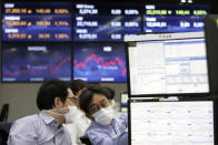 Currency traders work at the foreign exchange dealing room of the KEB Hana Bank headquarters in Seoul, South Korea, Wednesday, Sept. 23, 2020. Asian markets were mostly lower on Wednesday as investors kept a wary eye on how the coronavirus pandemic will affect the economic outlook. (AP Photo/Ahn Young-joon)