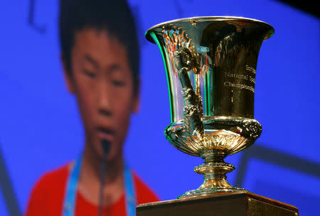 The championship trophy sits in front of a video screen as a student competes in the 89th annual Scripps National Spelling Bee at National Harbor in Maryland, U.S., May 25, 2016. REUTERS/Kevin Lamarque