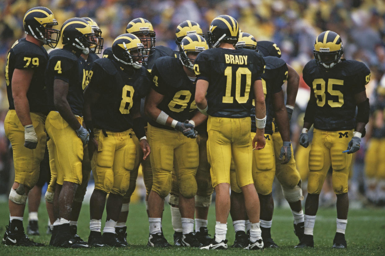 Tom Brady #10 Quarterback for the University of Michigan Wolverines instructs his offensive line in the huddle during the NCAA Division I-A Big 10 college football game against the Purdue University Boilermakers on 2nd October 1999 at the Michigan Stadium in Ann Arbor, Michigan, United States.The Michigan Wolverines won the game  38 - 12.  (Photo by Harry How/Getty Images)