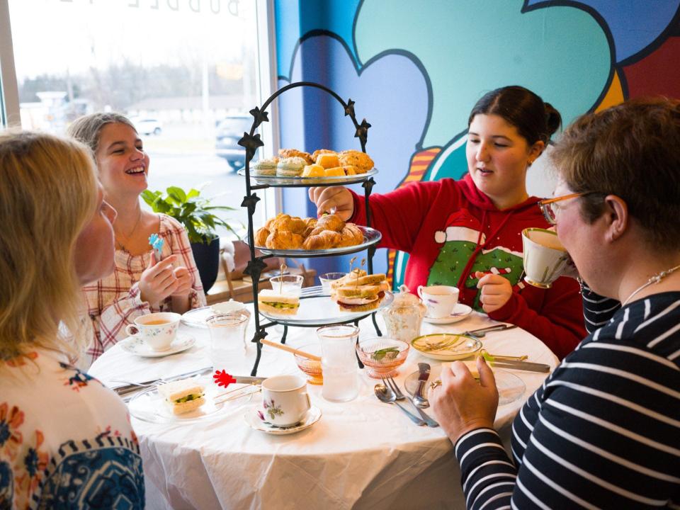 Scenes from the recent Christmas Tea Service at DaCapo Summerlyn coffeehouse are shown.