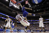 FILE - In this March 24, 2013, file photo, Florida Gulf Coast's Chase Fieler, top, dunks over San Diego State's Deshawn Stephens during the first half of a third-round game of the NCAA college basketball tournament in Philadelphia. The Dunk City Effect, as it's called, accounted for a 35 percent increase in freshman applications following the NCAA run, boosted enrollment from about 13,000 to more than 15,000, and the academic reputation has been enhanced with higher caliber students being admitted. (AP Photo/Matt Slocum, File)