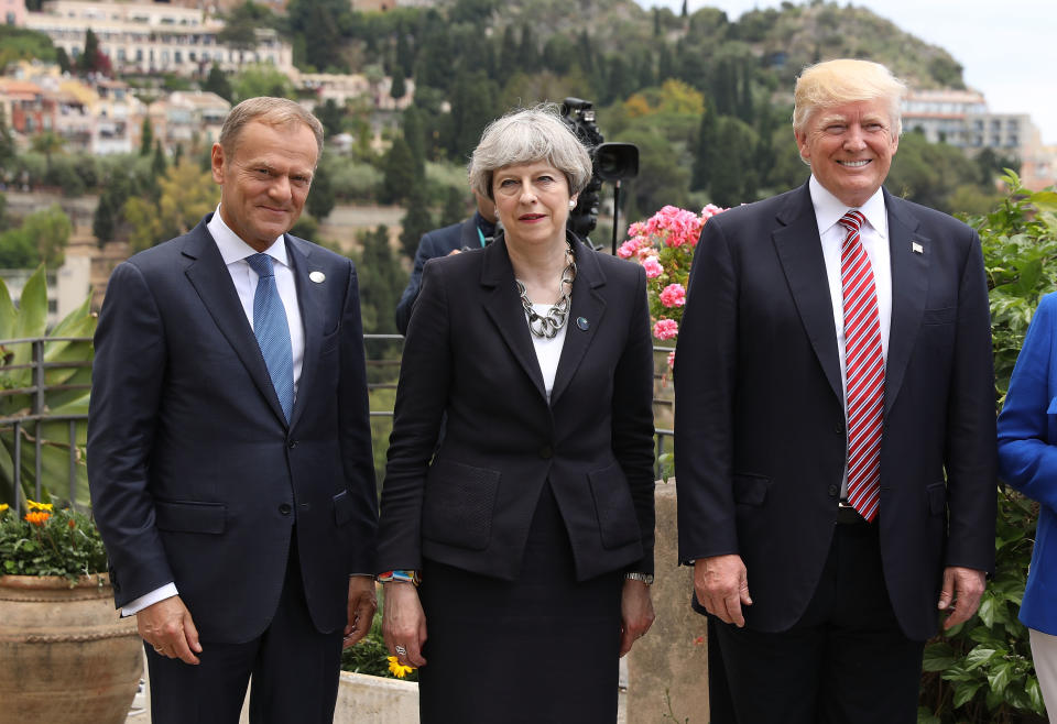 Theresa May stands between EU's Donald Tusk and US President Donald Trump at a summit in 2017