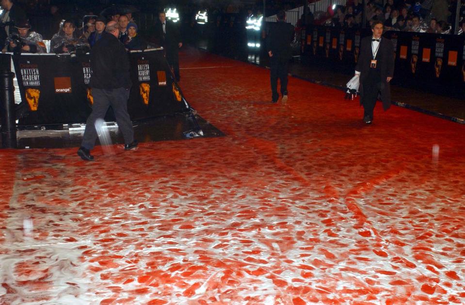 The stars of the big screen leave their footprints on a very wet  red carpet after their arrived for the Orange British Academy Film Awards at the Odeon cinema in London's Leicester Square.   (Photo by Yui Mok - PA Images/PA Images via Getty Images)