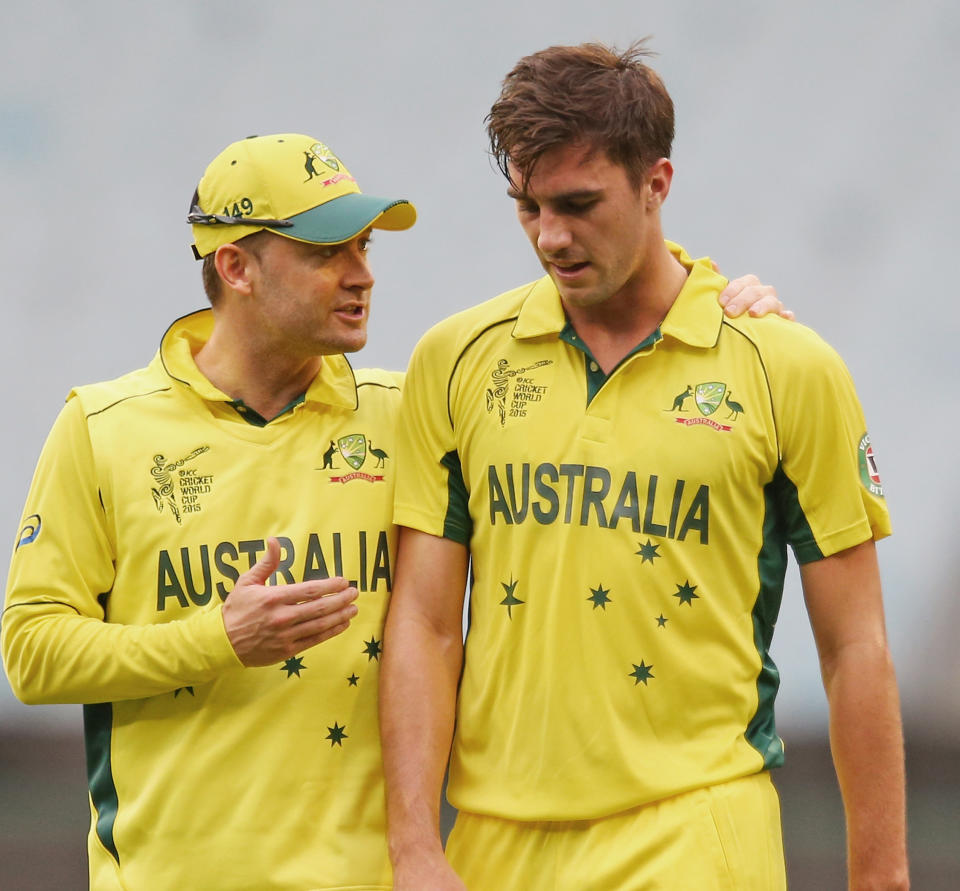 Michael Clarke pictured talking to bowler Pat Cummins