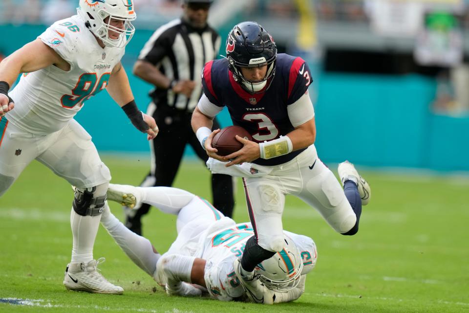 Miami Dolphins linebacker Jaelan Phillips (15) grabs Houston Texans quarterback Kyle Allen (3) during the second half of an NFL football game, Sunday, Nov. 27, 2022, in Miami Gardens, Fla. (AP Photo/Lynne Sladky)