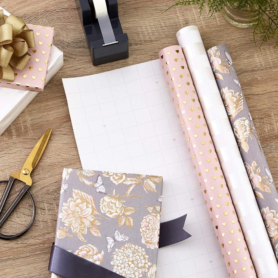 <p>If you're all about that soft glam, romantic aesthetic, the <span>Hallmark Premium Wrapping Paper with Gold Hearts, Rose Flowers, White Stripes </span> ($20 for three) is something you should consider. With golden hearts, rose florals, and white strip patterns, these rolls are perfect for beyond the holiday season as well. It even has cut lines on the back for easy wrapping. </p>