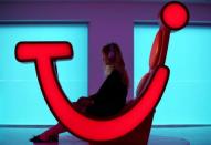 A woman demonstrates a prototype of a new TUI holiday-selection service as the company announced the rebranding of its UK operation, in London, Britain, October 17, 2017. Picture taken on October 17, 2017. REUTERS/Hannah McKay