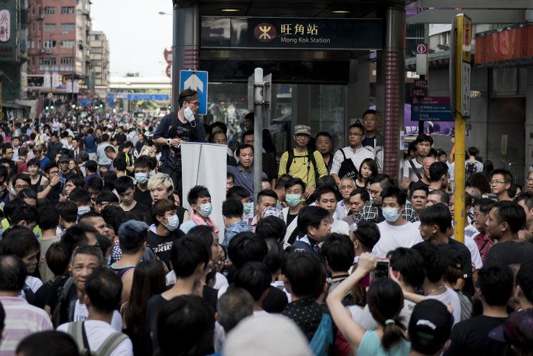 Protesters argue with a man opposing pro-democracy demonstrations as they block the Mongkok MTR station next to Nathan Road