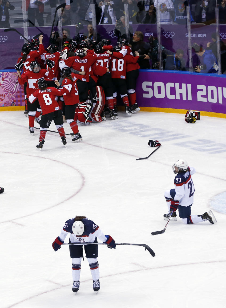 Anne Schleper of the United States (15) and Michelle Picard (23) react after the women's gold medal ice hockey game against Canada at the 2014 Winter Olympics, Thursday, Feb. 20, 2014, in Sochi, Russia. (AP Photo/Petr David Josek)