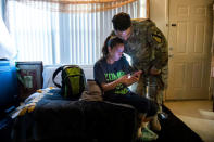 FILE PHOTO: Leanne Bell, 39, and her husband Spc. Tevin Mosley, 26, react to local residents posts regarding mold and housing related issues on a community Facebook group at the army base housing allocated to their family in Fort Hood, Texas, U.S. May 16, 2019. Bell and her family say they are vacating the home immediately after Mosley's military service contract expires in May. Since moving into the home 3 years ago, the family says they have experienced severe breathing issues, rashes, depression and hair loss, they believe is attributed to a mold infestation. REUTERS/Amanda Voisard