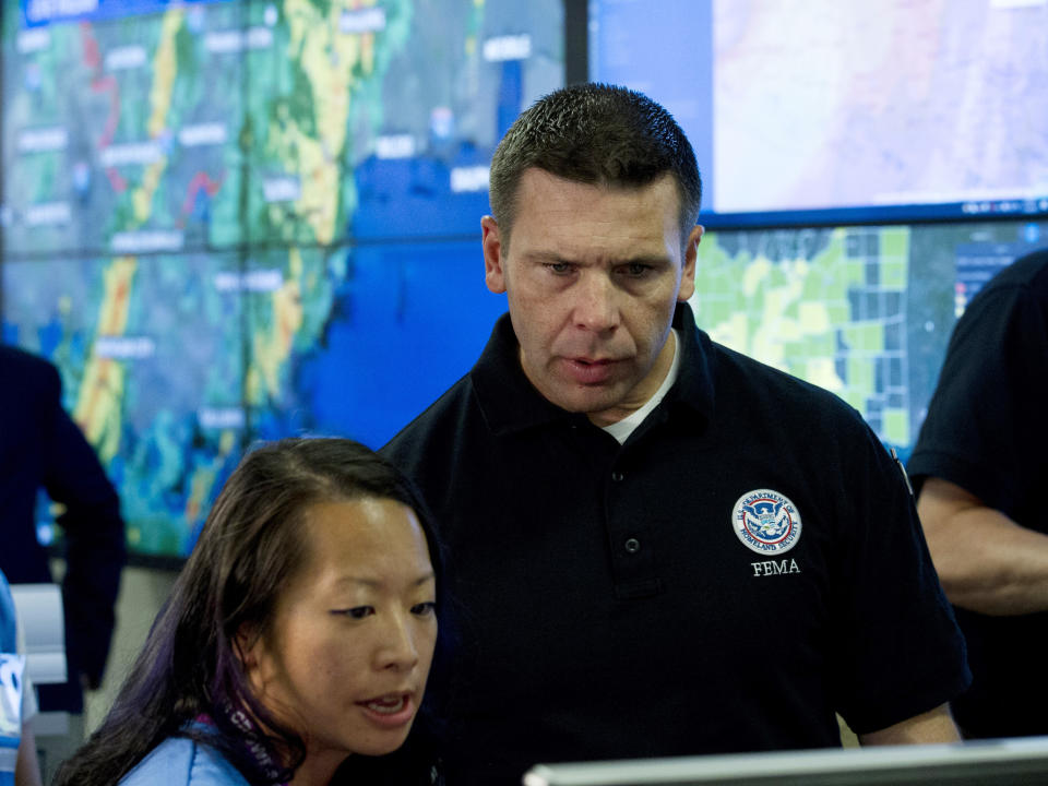 Acting Homeland Security Secretary Kevin McAleenan speaks with FEMA personnel, as he gets information about a storm system, in a visit to the National Response Coordination Center at FEMA headquarters in Washington, Sunday, July 14, 2019. (AP Photo/Jose Luis Magana)