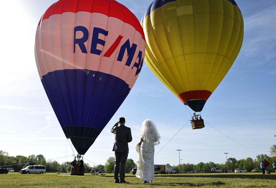 A bride and groom look on before a planned mass wedding of over 200 couples at the Total Eclipse of the Heart festival in Russellville, Ark.<span class="copyright">Mario Tama—Getty Images</span>