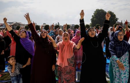 Kashmiri women shout pro-freedom slogans before offering the Eid-al-Adha prayers at a mosque during restrictions after the scrapping of the special constitutional status for Kashmir by the Indian government, in Srinagar