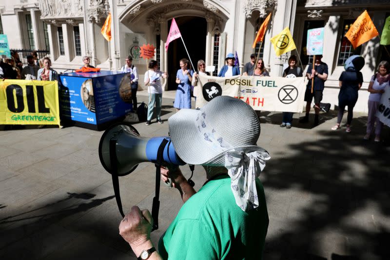 Climate activists await a ruling on whether planning permission granted for oil wells in southern England was lawful, outside the Supreme Court in London