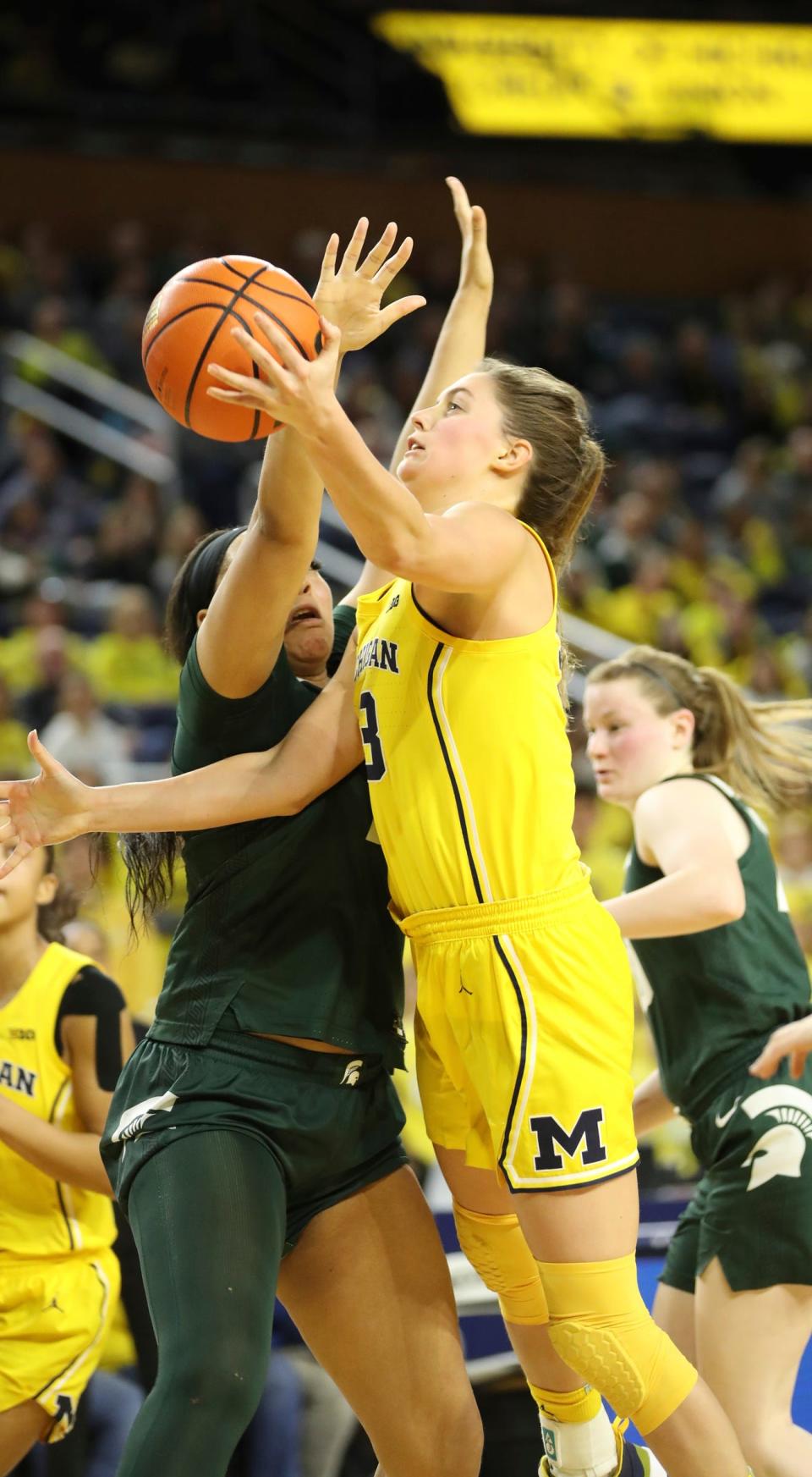 Michigan Wolverines forward Emily Kiser (33) scores against Michigan State Spartans forward Taiyier Parks (14) during fourth-quarter action at Crisler Center in Ann Arbor on Saturday, Jan. 14, 2023.