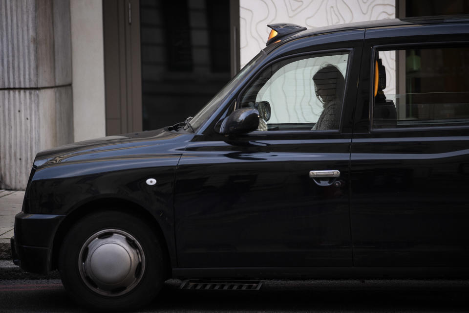 A driver seemingly asleep in a black cab queuing for a fare outside London Victoria railway station (Victoria Jones/PA)