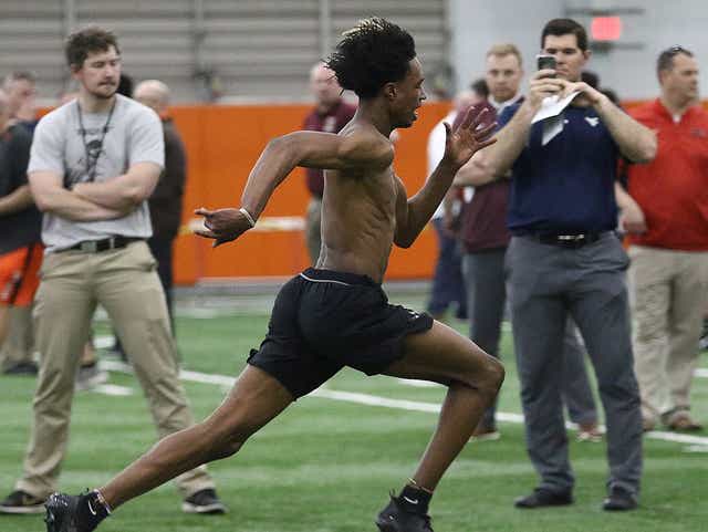 Massillon's Andrew Wilson-Lamp runs the 40-yard dash as West Virginia linebackers coach Blake Seiler films him during the 2019 Massillon Division I college showcase.