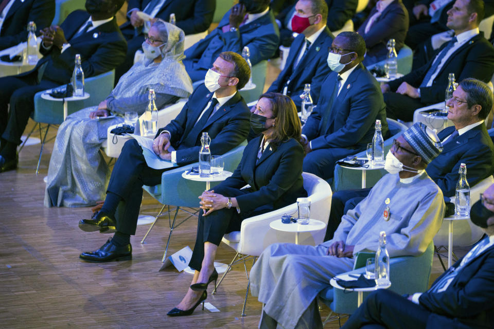 French President Emmanuel Macron, left, and Vice President Kamala Harris watch a welcome video at the beginning of the Paris Peace Forum, Thursday, Nov. 11, 2021 in Paris. The forum focuses on gaps in global health, post-COVID recovery and looking ahead for new principles of action for the post-COVID world. (Sarahbeth Maney/The New York Times via AP, Pool)