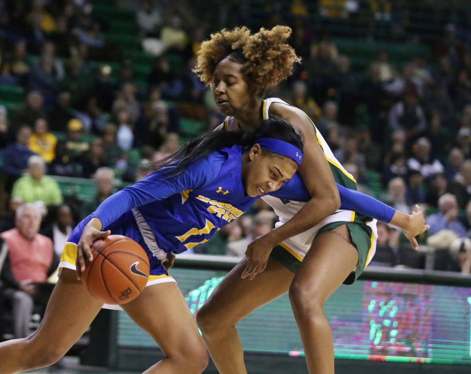 Morehead State guard Ariel Kirkwood, left, drives into Baylor guard DiDi Richards, right, in the second half of an NCAA college basketball game, Monday, Dec. 30, 2019, in Waco, Texas. (Rod Aydelotte/Waco Tribune Herald, via AP)