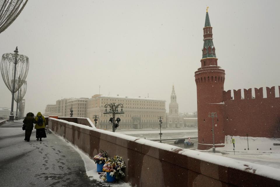 Years later, flowers mark the bridge where Russian opposition leader Boris Nemtsov was gunned down, Feb. 7, 2022.