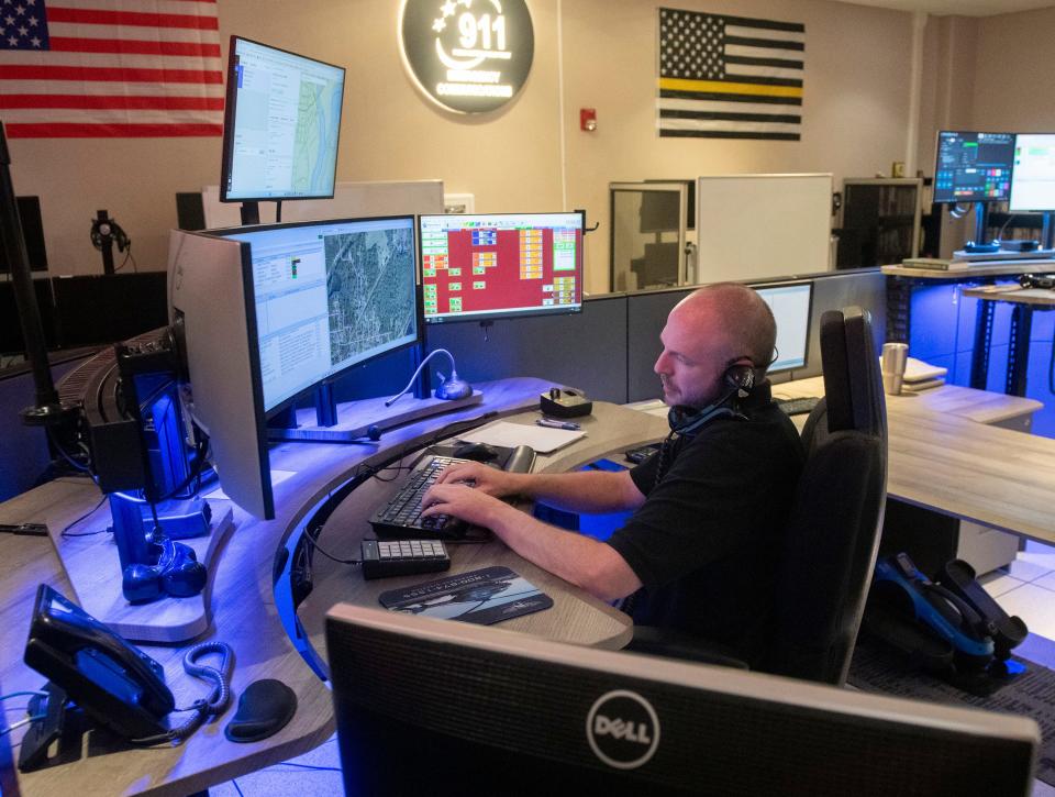 Santa Rosa County Emergency Communication Center operator Adam Weston takes a 911 call on Thursday, Aug. 3, 2023. Santa Rosa County is considering a plan to rebuild and consolidate the county emergency dispatch center into one facility.