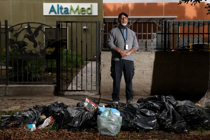 LOS ANGELES, CA - MAY 04: William Taylor, 70, stands in front of bags of trash along Beach St off of Century Ave in Watts on Thursday, May 4, 2023 in Los Angeles, CA. Illegal dumping plagues many Los Angeles neighborhoods. The blight drives down property values and leaves the overwhelmingly Black and Latino residents fuming. (Gary Coronado / Los Angeles Times)