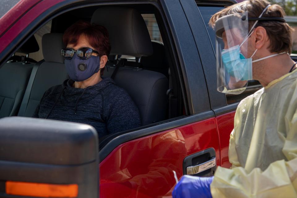 Denise Walter, an employee at Gallup Medical Center in New Mexico, waits in her truck for Dr. Jason Sobkowski to administer a COVID-19 test.