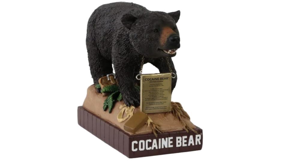 The first Cocaine Bear bobblehead has been released. The $30 limited edition display features to famous black bear standing on a duffle bag of cocaine with a plaque detailing its cocaine-induced demise.