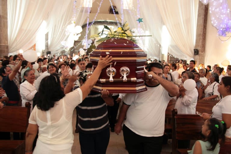 Mourners carry the coffin of priest Gregorio Lopez at his funeral in Altamirano