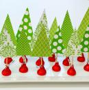 <p>Use Hershey Kisses wrapped in holiday-color foils to make this ultra-easy project: Cut triangles from scrapbooking paper to represent trees, and let kids poke them into the top of the Kisses with toothpicks. Arrange them on a platter for a table centerpiece that's homemade, affordable… and delicious, too.</p><p><em><a href="https://www.itallstartedwithpaint.com/christmas-crafts-with-kids-kisses/" rel="nofollow noopener" target="_blank" data-ylk="slk:Get the tutorial at It All Started With Paint »;elm:context_link;itc:0;sec:content-canvas" class="link ">Get the tutorial at It All Started With Paint »</a></em></p>