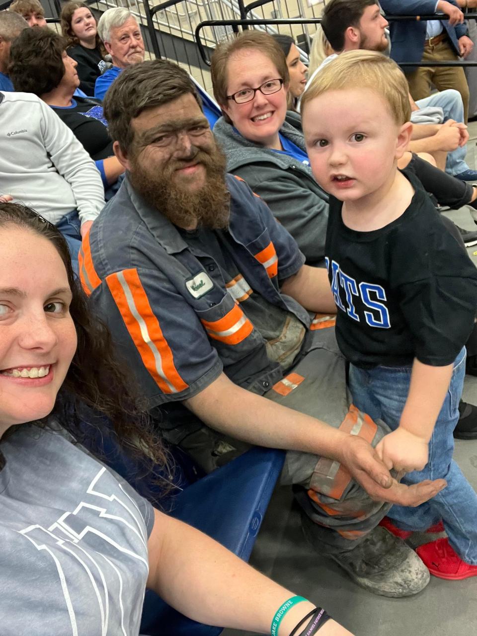 Mollie McGuire (left), Micheal McGuire and their son Easton at the Blue-White Scrimmage