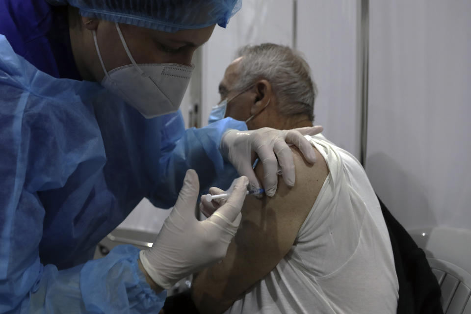 A man receives a Pfizer COVID-19 vaccine at Saint George Hospital University Medical Center, in Beirut, Lebanon, Tuesday, April 6, 2021. Human Rights Watch, a leading rights group, said Tuesday that Lebanon's vaccination campaign has been slow and risks leaving behind some of the country's most vulnerable people, including Palestinian and Syrian refugees, as well as migrant workers. (AP Photo/Bilal Hussein)