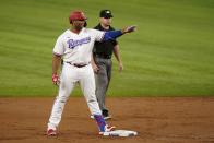 Texas Rangers' Curtis Terry stands on the bag in front of umpire Nick Mahrley after hitting a double off of Los Angeles Angels starter Chris Rodriguez in the second inning of a baseball game in Arlington, Texas, Monday, Aug. 2, 2021. It was Terry's first major league hit. (AP Photo/Tony Gutierrez)