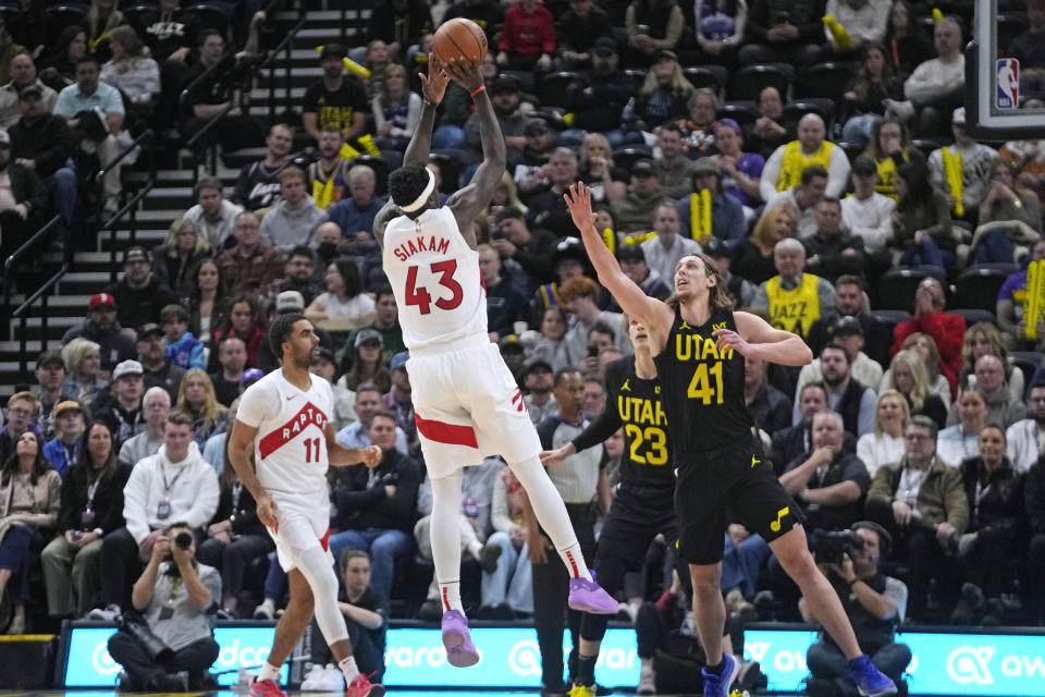 Toronto Raptors forward Pascal Siakam (43) shoots as Utah Jazz forward Kelly Olynyk (41) defends during the first half of an NBA basketball game Friday, Jan. 12, 2024, in Salt Lake City. (AP Photo/Rick Bowmer)