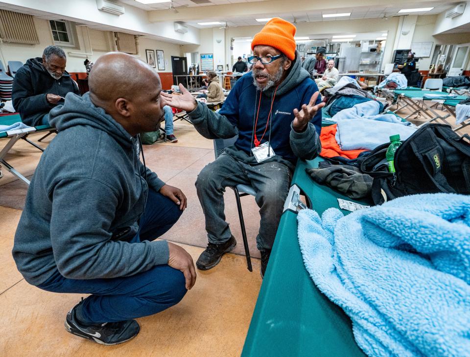 Kenny Howard, left, the assistant director for Capuchin Community Services in Milwaukee, checks in with guest David Taylor at St. Ben's overnight warming center on Wednesday January 17, 2024 in Milwaukee, Wis.