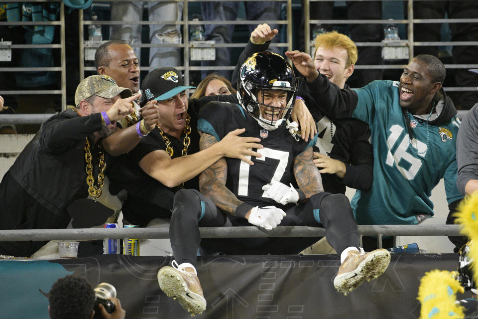 Fans cheer Jacksonville Jaguars tight end Evan Engram (17) after scoring a touchdown during the first half of an NFL football game against the Cincinnati Bengals, Monday, Dec. 4, 2023, in Jacksonville, Fla. (AP Photo/Phelan M. Ebenhack)