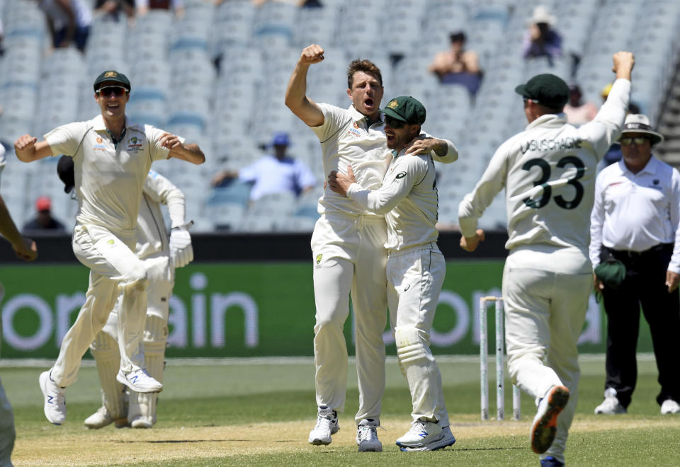 Australia's James Pattinson, center, celebrates with teammates after capturing the wicket of New Zealand's Kane Williamson during their cricket test match in Melbourne, Australia, Sunday, Dec. 29, 2019. (AP Photo/Andy Brownbill)